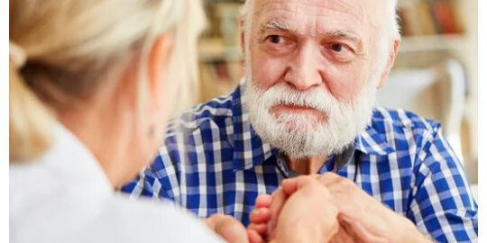 Elderly person reviewing a will with a family member.