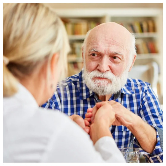 Elderly person reviewing a will with a family member.