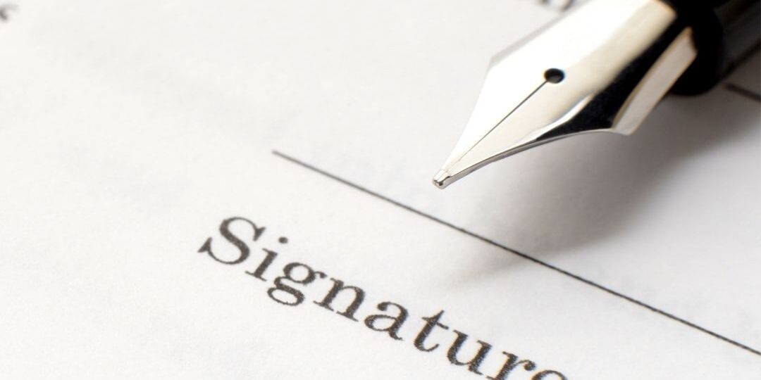 Person signing a will with legal papers and family photos representing celebrity inheritance decisions.