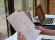 Executor reviewing a will and probate documents before stepping down.